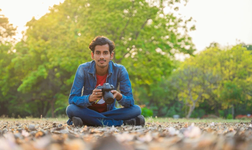 the young man is taking pictures in the field