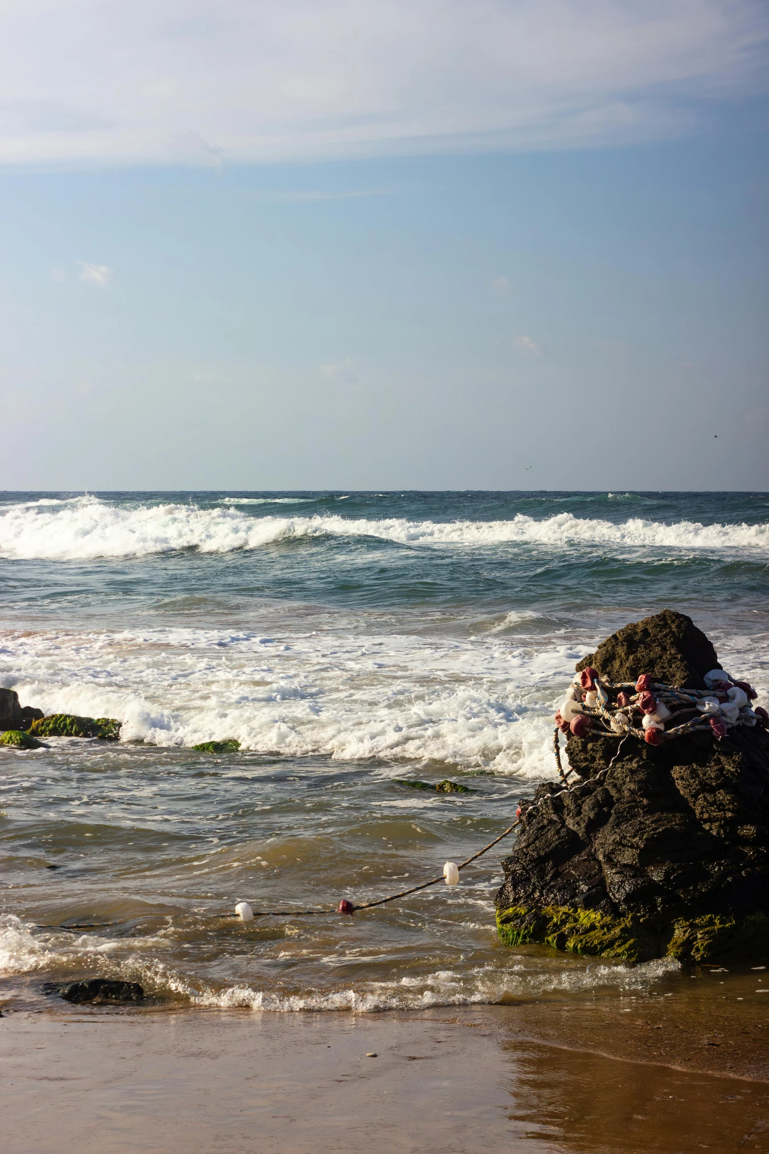 a sandy beach with waves crashing in the background