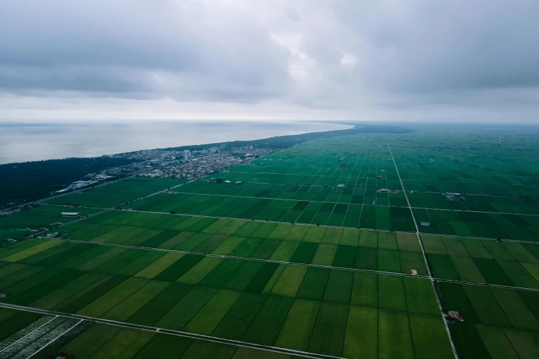 the fields below are almost as far away as possible from the land below are large, green grassy areas