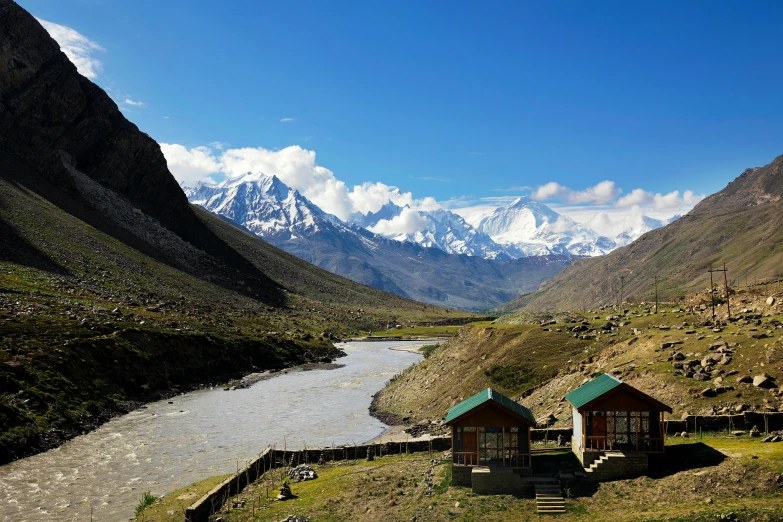 the view of a river and mountains in the valley