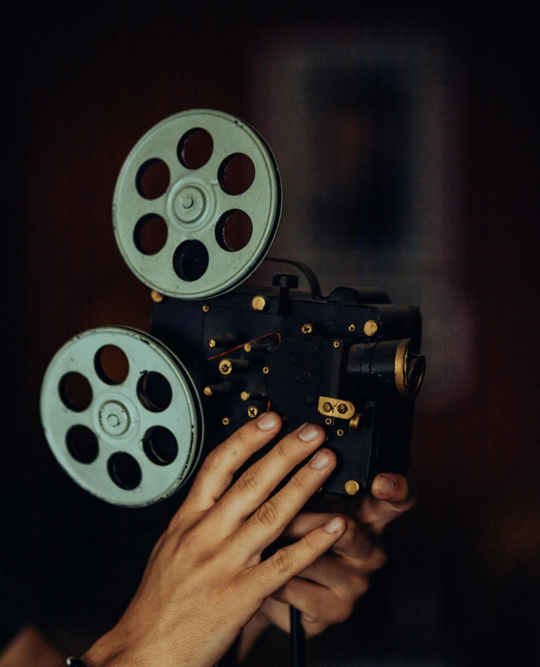 a person holding up an old movie projector