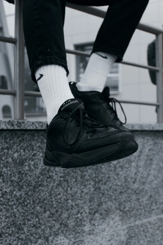 a close up of someone in sneakers climbing a railing