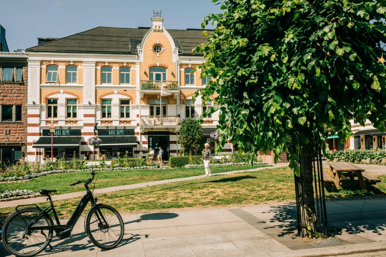 two bicycles parked in front of large brick building