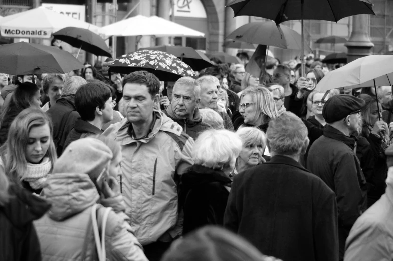 a crowd of people walking around a market