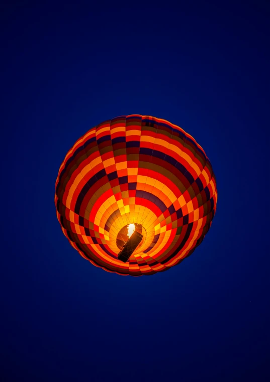 a ballon is seen in the dark blue sky