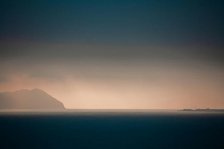 a large body of water under a cloudy sky