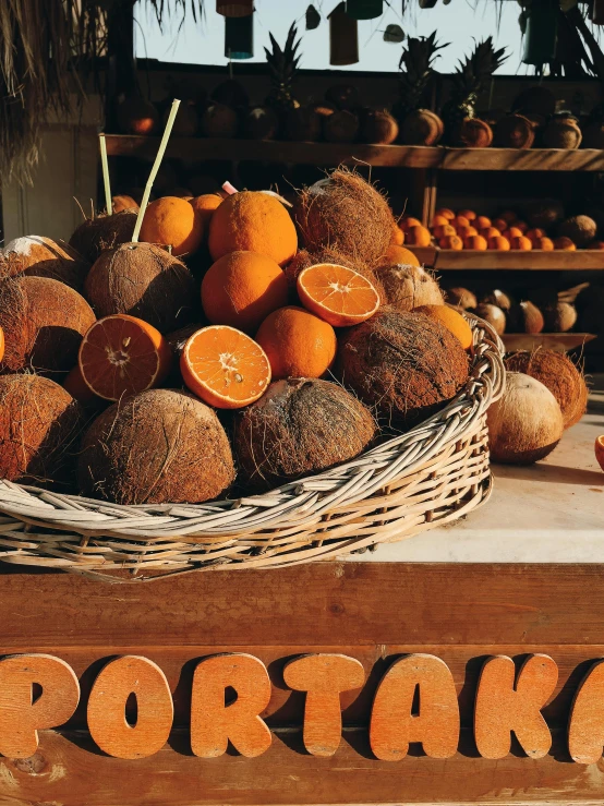 a basket full of oranges and some other vegetables