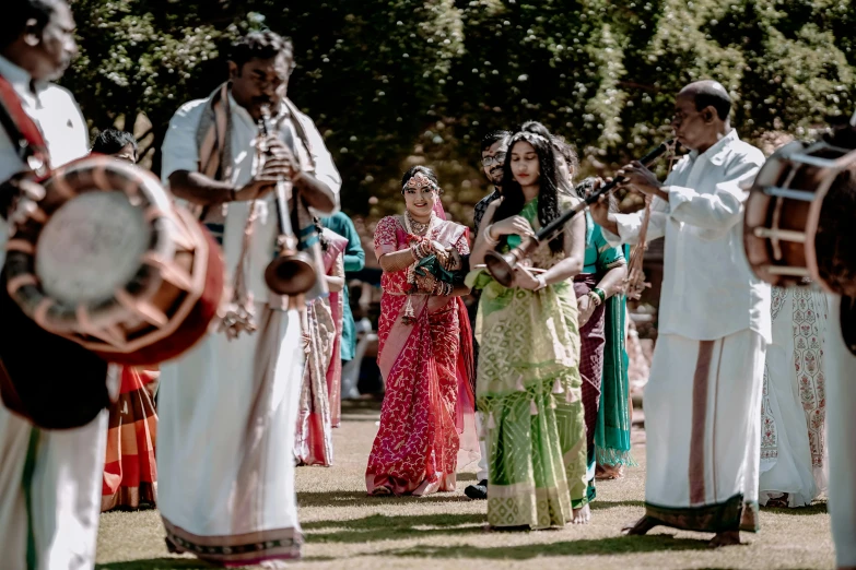 a group of people standing around each other while holding instruments