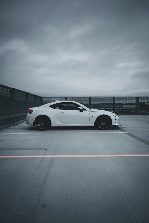 a car parked in the middle of an empty parking lot