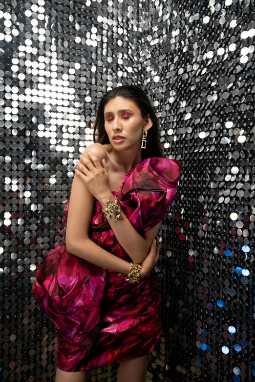 woman in pink dress with gold jewelry and huge sequins