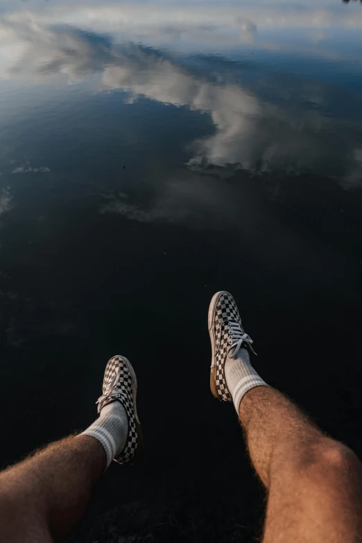 two feet are standing on a surface that looks like water