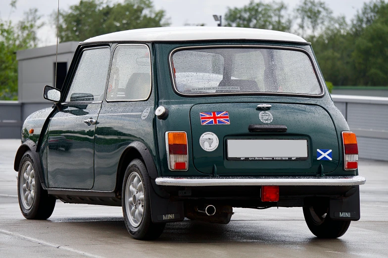 a small green compact car parked in the parking lot