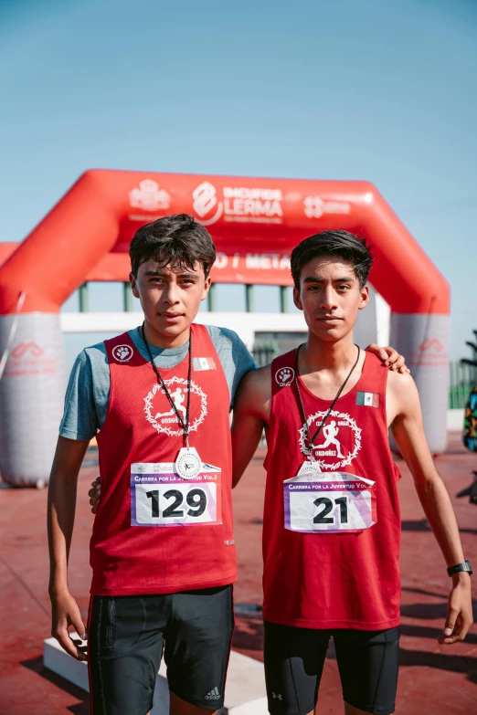 two men who are standing in front of a gate