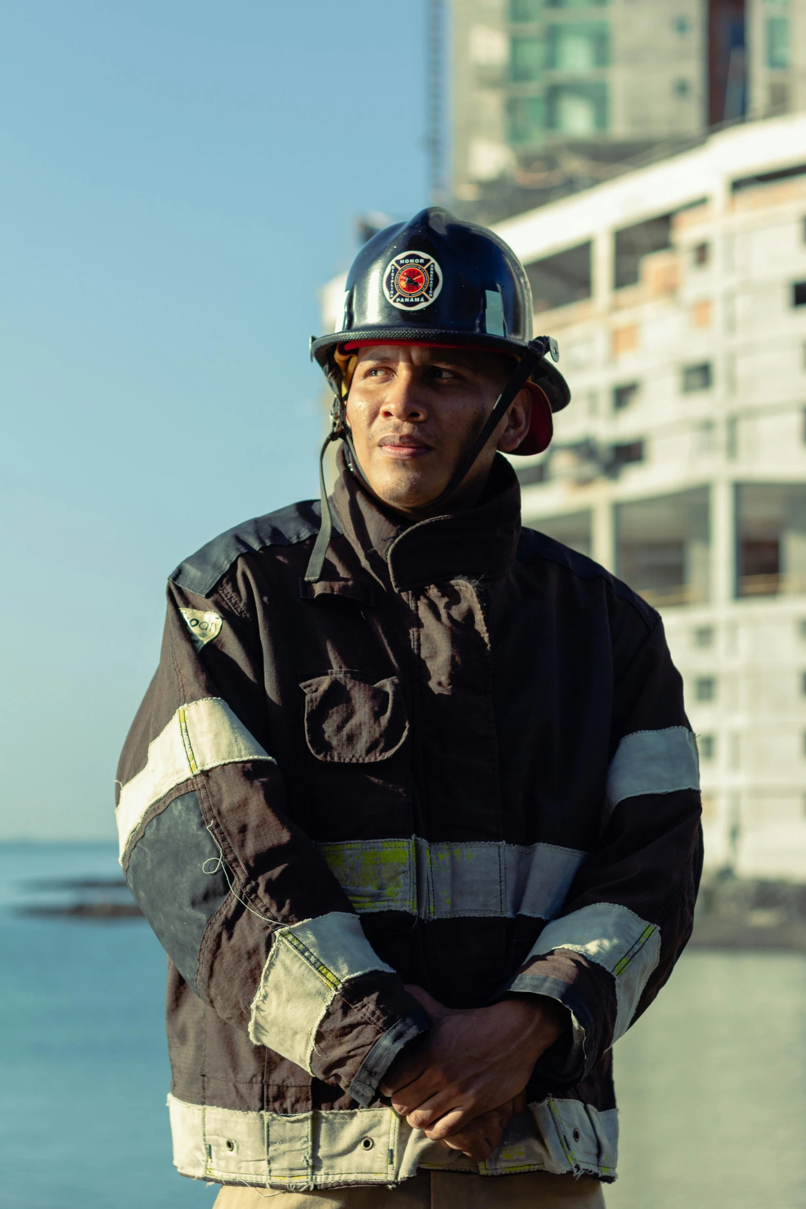 a firefighter posing for a po by the ocean