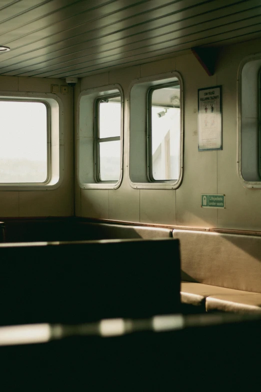 a train with windows next to benches in it