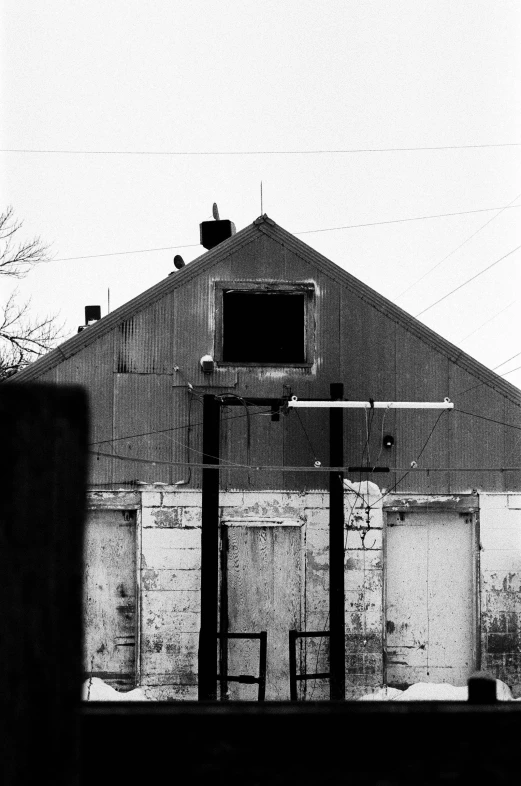 an old white building with power lines above it