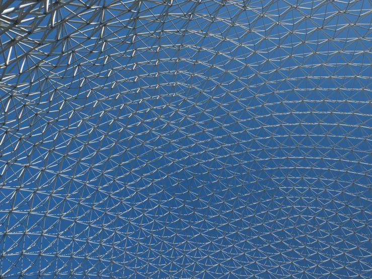 looking up at the underside of a structure with blue sky