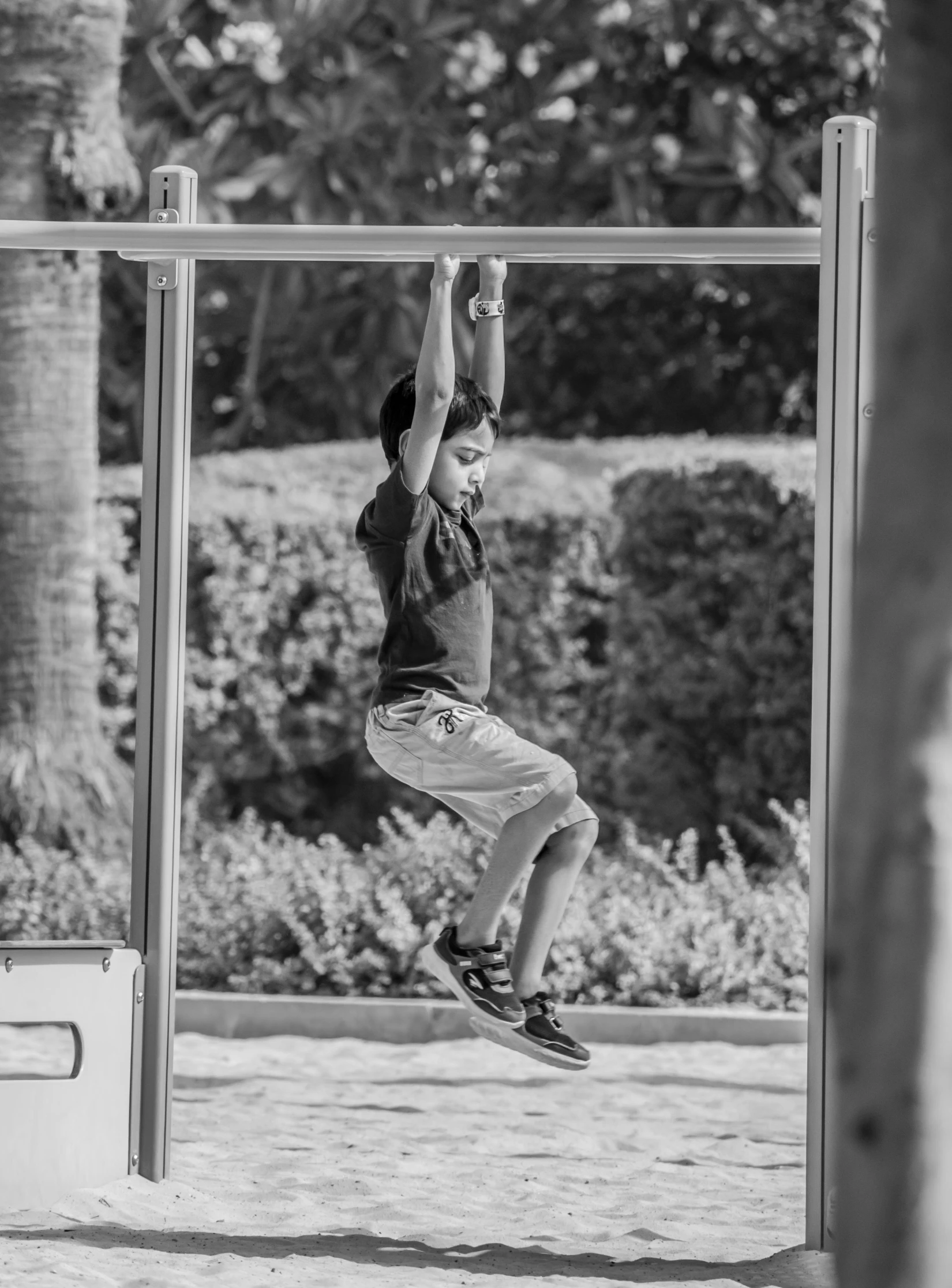 a child hanging upside down on a basketball hoop