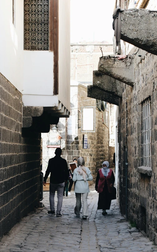 people are walking on a cobblestone street