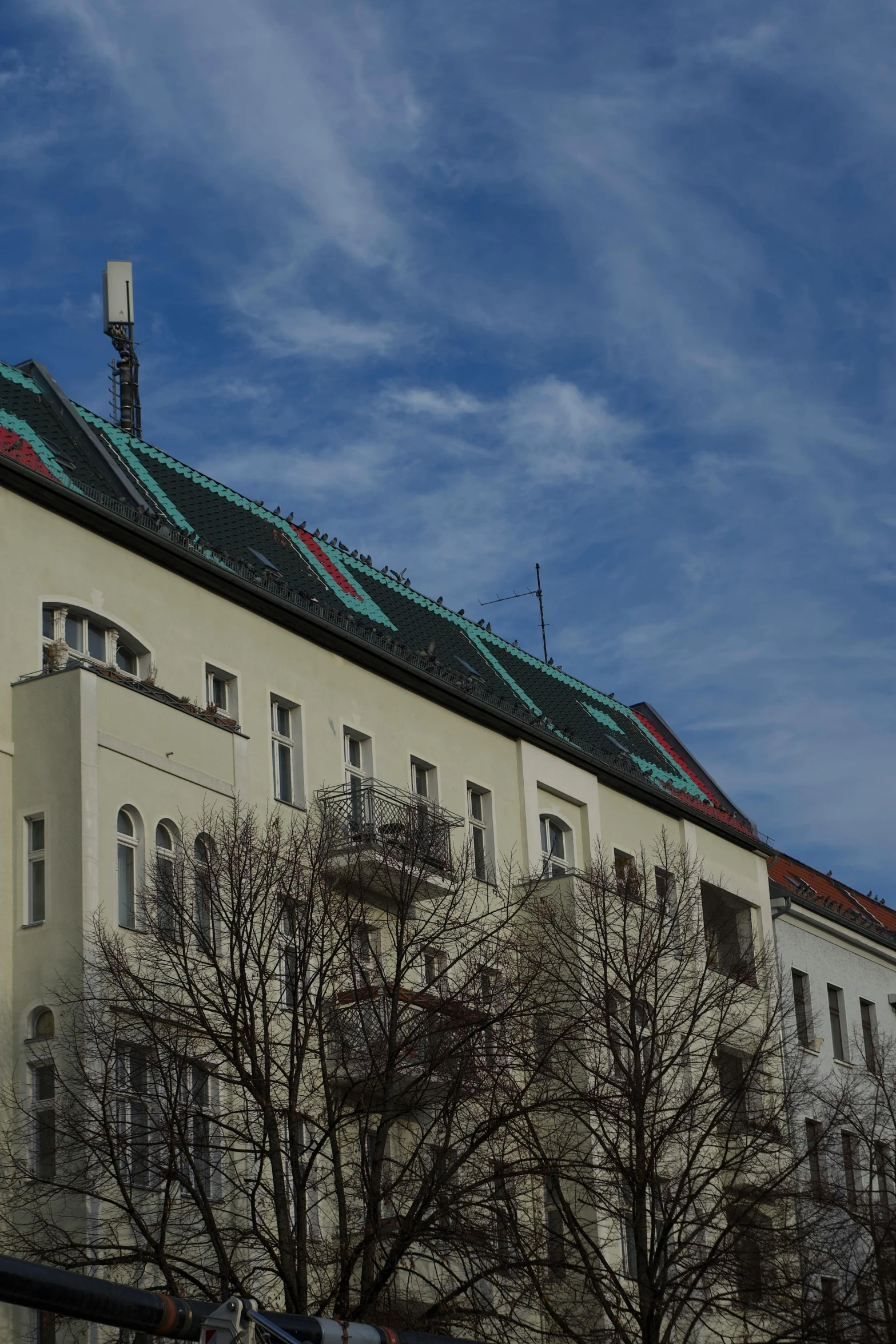 two story buildings, a clock and a sky background