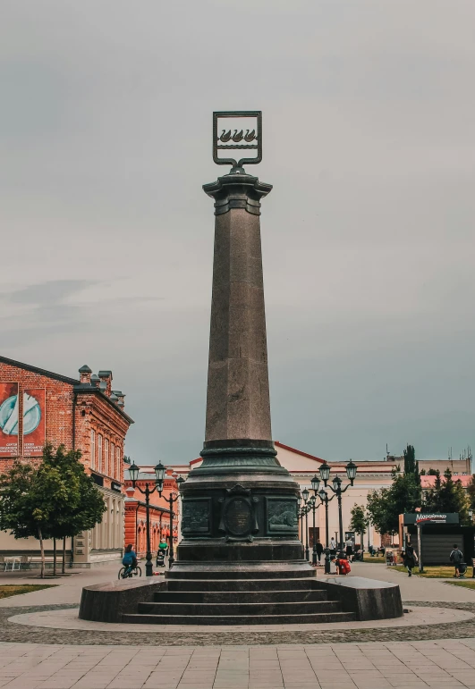 a statue in the middle of a cement ground