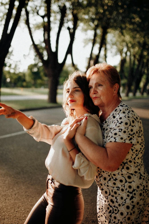 an older woman is taking a po with her phone while standing next to another young woman