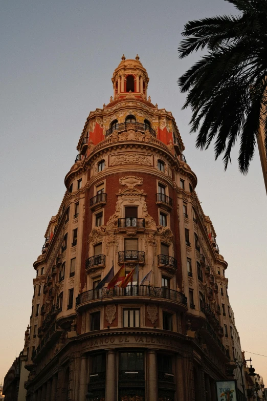 a building that has a red clock on it's face