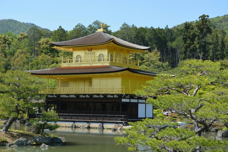 the pagoda on the water is built in the woods