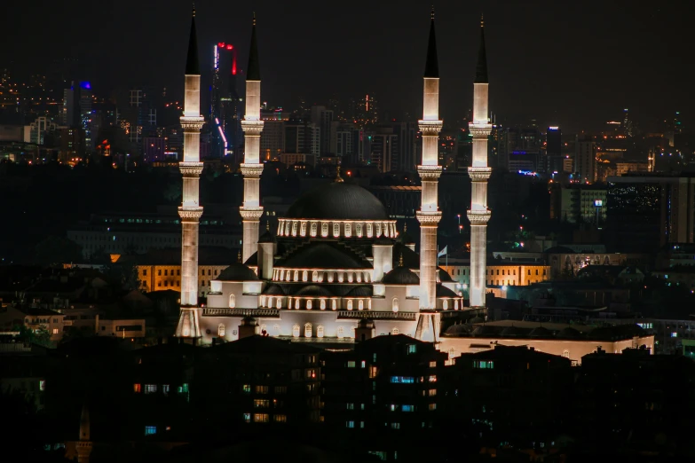 a very large cathedral with lights around it in the city