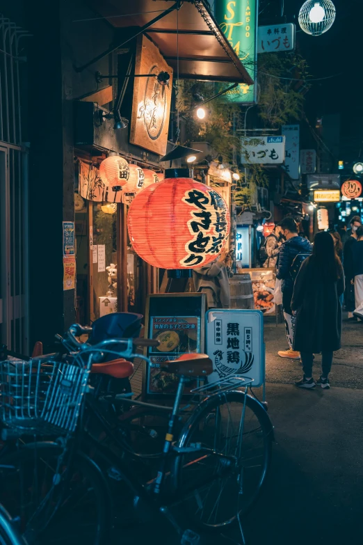 a night scene with people walking and bikes