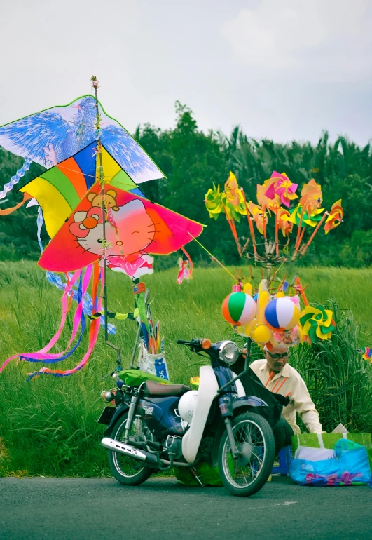 a motorcycle with a child and a kite