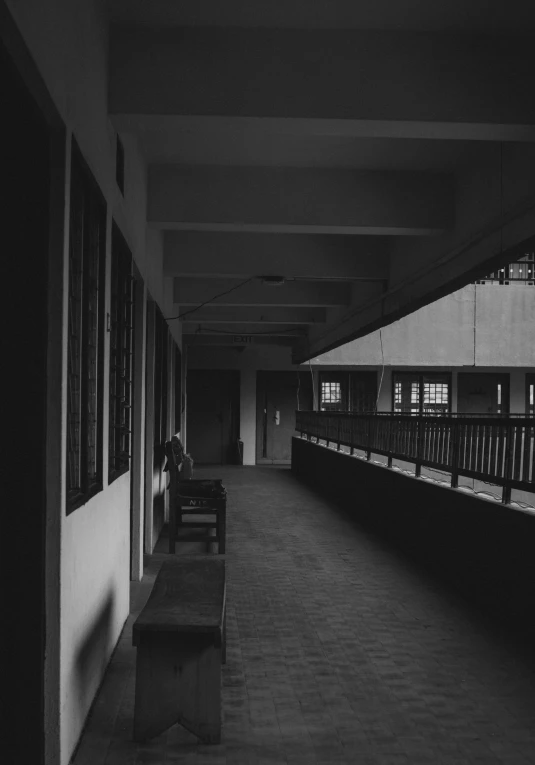 the empty walkway leading to the second floor with benches