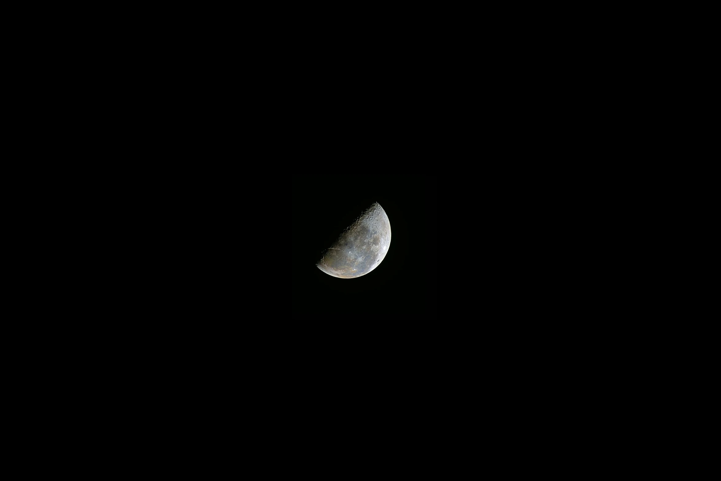 a half moon taken from the side of a plane