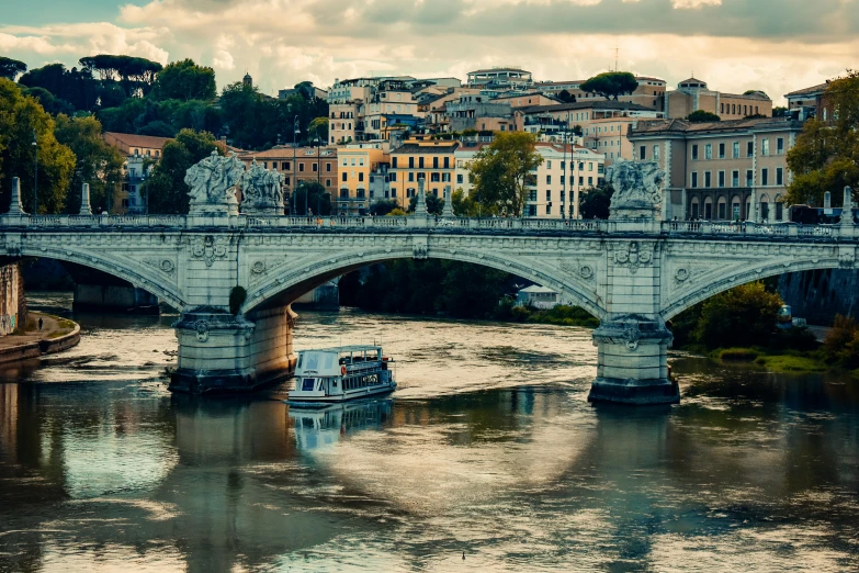 a boat on the river in front of a bridge