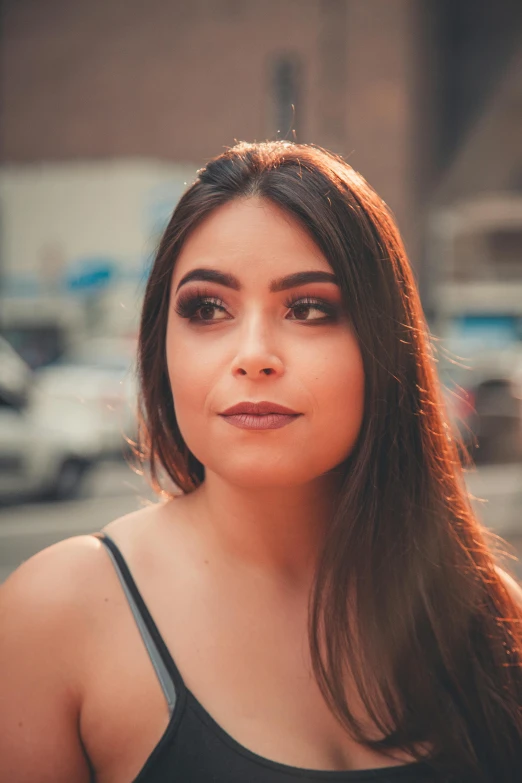 a beautiful young woman with long hair looking into the distance