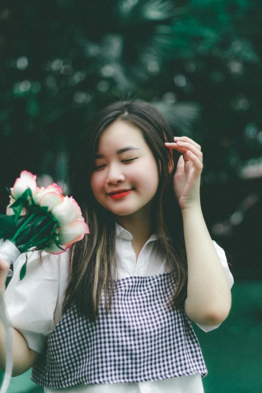 a  holding a flower and smiling