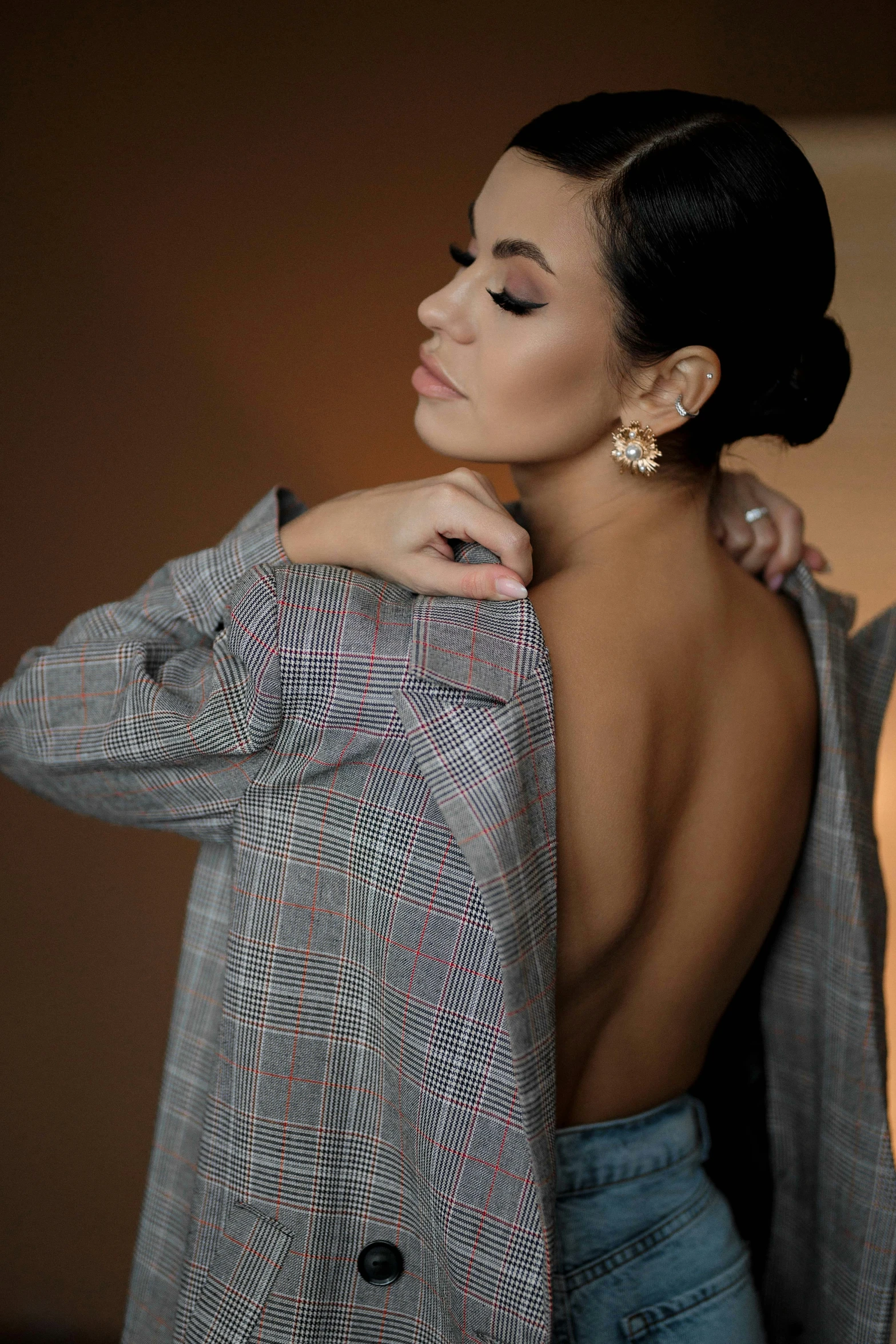 a black woman is posing with her coat