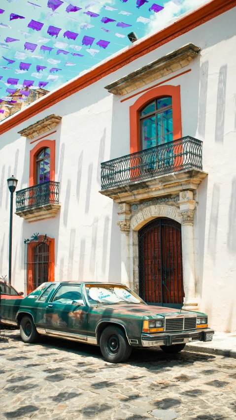 an old car parked in front of a building