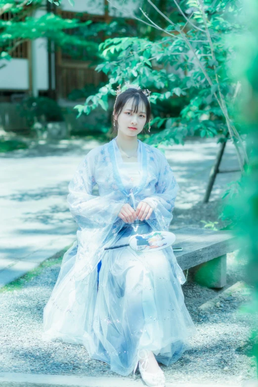 a person sitting on a bench wearing a blue outfit