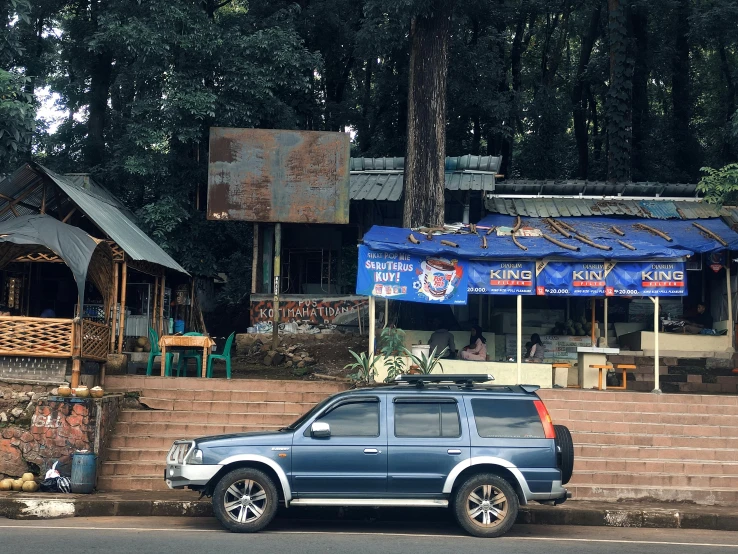 a car parked on a sidewalk in front of houses