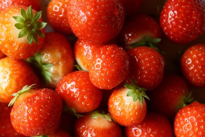 a group of red strawberries are arranged together