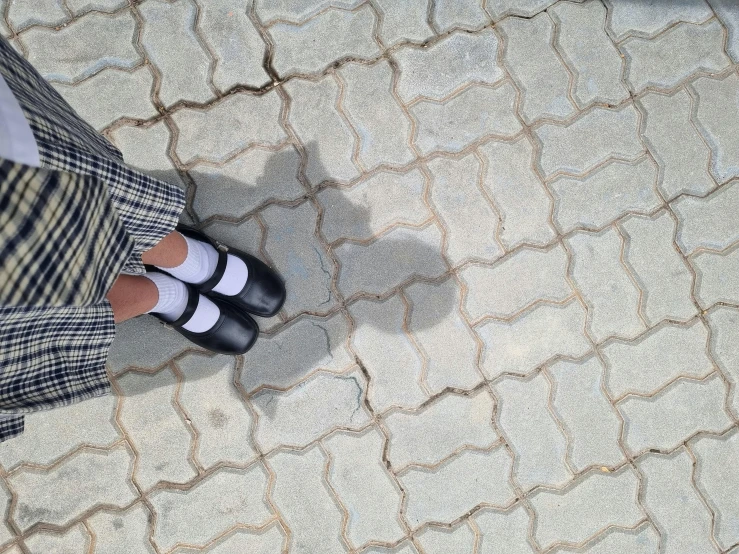 a person wearing white shoes standing on a carpet