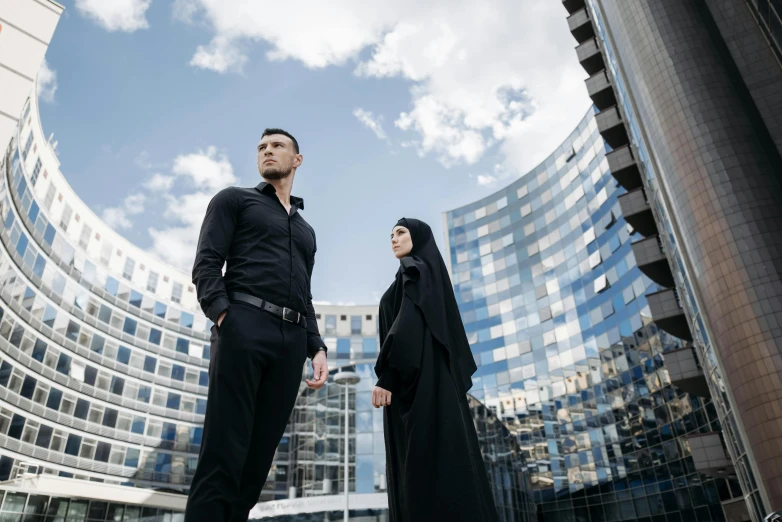 two people stand in front of a building