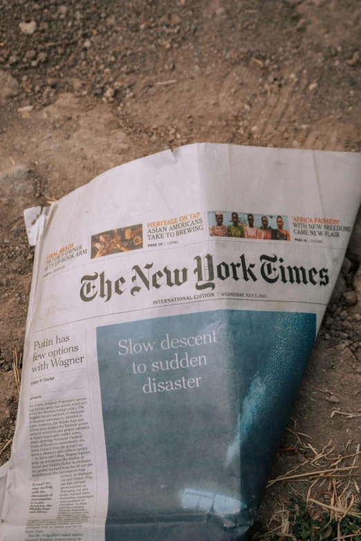 an image of a newspaper lying on the ground