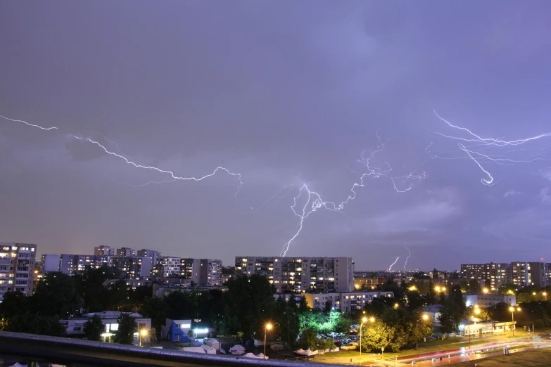 lightning striking from the sky above a city