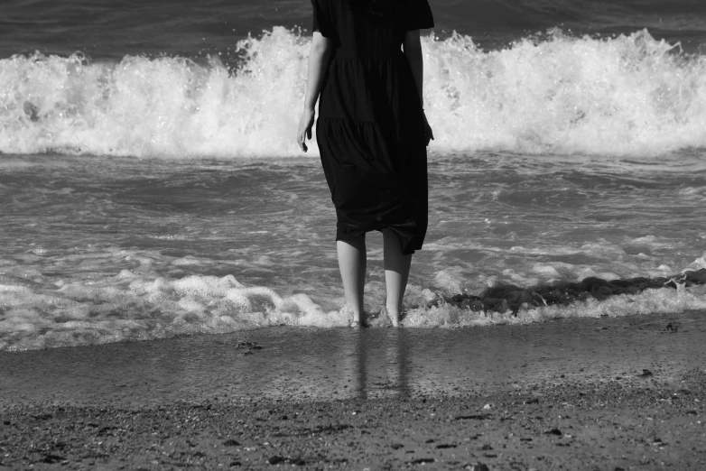 there is a woman standing on the beach