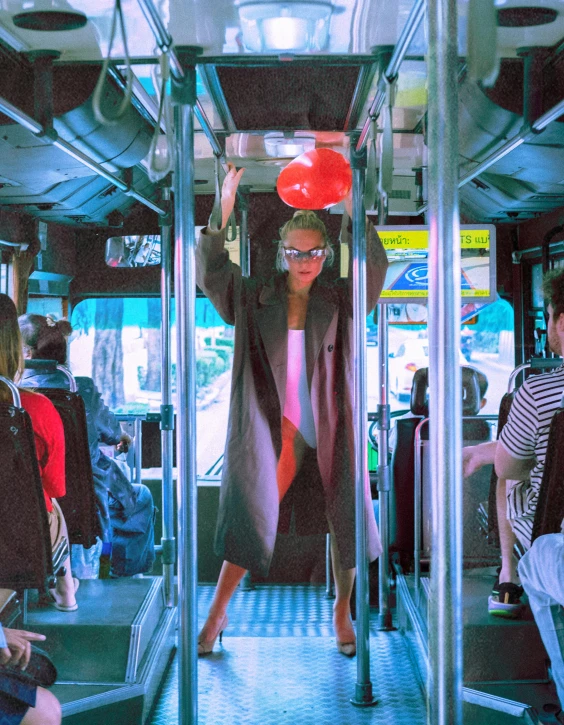 a woman in sunglasses rides in a bus