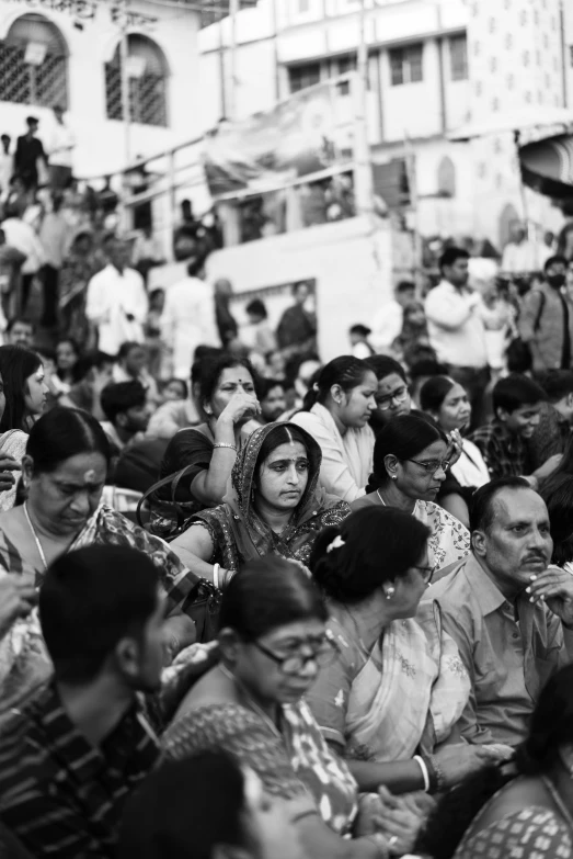 a crowd of people standing around each other