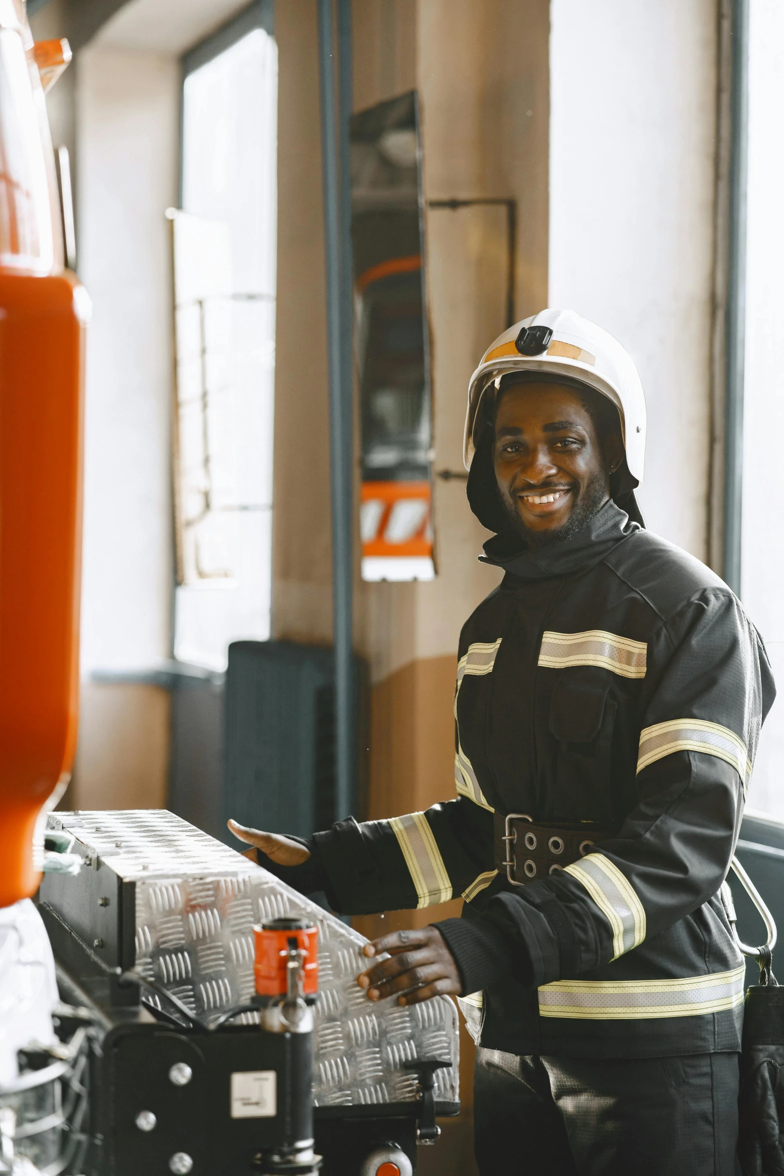 a smiling firefighter in his uniform