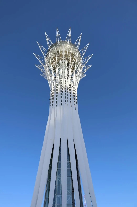 tall white building against a blue sky with a clock